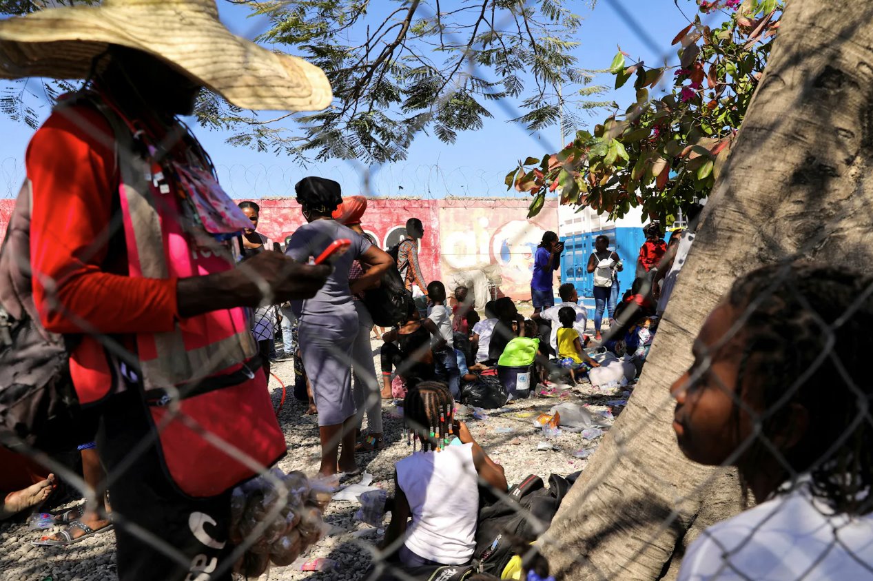 2024年2月12日，海地太子港，敵對幫派之間發(fā)生槍戰(zhàn)后，逃離暴力的人們抵達(dá)海地國家警察局。